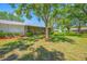 The backyard has a screened in lanai, manicured landscaping and mature trees around the property at 70 Cypress Pl, Oldsmar, FL 34677