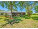 Well-maintained backyard with a screened porch and beautiful landscaping, offering a relaxing outdoor space at 70 Cypress Pl, Oldsmar, FL 34677