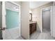 Bathroom with granite countertops, wood cabinets, a walk-in shower and views into the bedroom at 70 Cypress Pl, Oldsmar, FL 34677