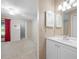 Bedroom opens up to bathroom featuring white vanity, lighting, and shuttered cabinet at 70 Cypress Pl, Oldsmar, FL 34677