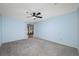 Spacious bedroom with neutral carpet and sliding door access to outdoor space at 70 Cypress Pl, Oldsmar, FL 34677