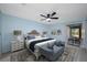 Stylishly staged bedroom with a ceiling fan and sliding door access to outdoor space at 70 Cypress Pl, Oldsmar, FL 34677
