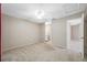 Primary bedroom with ceiling fan, access to walk in closet, and ensuite bathroom at 70 Cypress Pl, Oldsmar, FL 34677