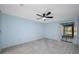 Bright bedroom with neutral carpet, a ceiling fan, and natural light at 70 Cypress Pl, Oldsmar, FL 34677