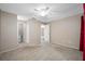 Primary bedroom with ceiling fan, access to the walk in closet, and ensuite bathroom at 70 Cypress Pl, Oldsmar, FL 34677