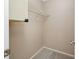 This empty closet features a neutral color palette, a wire shelf, and carpeted flooring at 70 Cypress Pl, Oldsmar, FL 34677