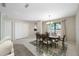 Dining area with tile floor, large windows, and views into the kitchen at 70 Cypress Pl, Oldsmar, FL 34677