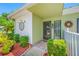 Charming home entrance with a decorative door and surrounding lush garden at 70 Cypress Pl, Oldsmar, FL 34677