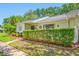 Charming home exterior featuring lush landscaping, mature trees, and a well-manicured lawn at 70 Cypress Pl, Oldsmar, FL 34677