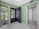 Inviting foyer featuring tile flooring, a decorative front door, and natural light from the adjacent window at 70 Cypress Pl, Oldsmar, FL 34677