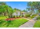 Landscaped front yard featuring palm trees and a decorative tree sculpture, adding curb appeal at 70 Cypress Pl, Oldsmar, FL 34677