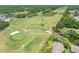 Beautiful golf course with pristine greens, a pond, and mature trees creating a scenic landscape at 70 Cypress Pl, Oldsmar, FL 34677