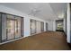 View of the screened lanai with ceiling fans and multiple sliding glass doors at 70 Cypress Pl, Oldsmar, FL 34677