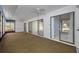 Screened lanai with ceiling fans and multiple sliding glass doors at 70 Cypress Pl, Oldsmar, FL 34677