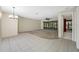 Bright living area featuring neutral carpet, tile flooring and access to an outdoor patio at 70 Cypress Pl, Oldsmar, FL 34677