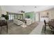 Inviting living room features stylish furniture, a ceiling fan, and access to the screened porch at 70 Cypress Pl, Oldsmar, FL 34677