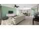 Open-concept living room featuring neutral tones, stylish furniture, and seamless flow to the dining area at 70 Cypress Pl, Oldsmar, FL 34677