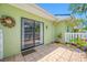 Tile patio with view of the house and lush landscaping at 70 Cypress Pl, Oldsmar, FL 34677