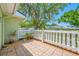 Private outdoor patio with mature tree and white picket fence at 70 Cypress Pl, Oldsmar, FL 34677