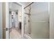 Renovated bathroom with glass-enclosed shower, tile surround, and granite-topped vanity at 70 Cypress Pl, Oldsmar, FL 34677