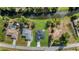 Overhead captures a house with a river alongside its large backyard, complemented by lush green trees at 7054 Rosemont Dr, Englewood, FL 34224