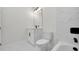Modern bathroom featuring white marble-style tile, sleek black fixtures, and a contemporary vanity at 7054 Rosemont Dr, Englewood, FL 34224