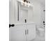 Bathroom featuring a white vanity with black hardware, and a toilet at 7054 Rosemont Dr, Englewood, FL 34224