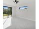 Bright bedroom with black-framed sliding glass door, a ceiling fan and large-format marble-look flooring at 7054 Rosemont Dr, Englewood, FL 34224