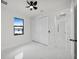 Bedroom featuring a ceiling fan, window, closet and view into the hallway at 7054 Rosemont Dr, Englewood, FL 34224