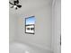 Bright bedroom with black-framed window and a view of neighborhood houses at 7054 Rosemont Dr, Englewood, FL 34224