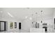Bright and airy living room features modern lighting, kitchen, black framed windows and sliding doors at 7054 Rosemont Dr, Englewood, FL 34224
