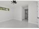 Minimalist main bedroom with bright white paint, recessed lighting, tile floors and bathroom view at 7054 Rosemont Dr, Englewood, FL 34224