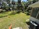 Large backyard with greenery, providing ample outdoor space and view of a window at 708 Keeling St, Brooksville, FL 34601