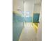 Bathroom featuring original blue and yellow tiling, a tub, and mosaic tile floors at 708 Keeling St, Brooksville, FL 34601