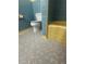 This bathroom features mosaic flooring, a toilet, and a yellow tub with classic blue tiles at 708 Keeling St, Brooksville, FL 34601