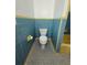 Charming bathroom featuring a toilet, patterned tile floors, and original blue and yellow tiling at 708 Keeling St, Brooksville, FL 34601