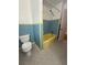 Retro bathroom with yellow bathtub, and blue and yellow tile at 708 Keeling St, Brooksville, FL 34601