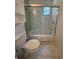 The bathroom has a toilet and shower with glass doors at 708 Keeling St, Brooksville, FL 34601