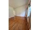 This is a bedroom with shining hardwood floors, neutral walls and one window at 708 Keeling St, Brooksville, FL 34601