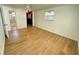The bedroom has wood-look flooring, two windows, paneled walls, and a ceiling fan at 708 Keeling St, Brooksville, FL 34601