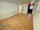 Spacious bedroom featuring a paneled wall, wood-look flooring, and a ceiling fan at 708 Keeling St, Brooksville, FL 34601