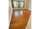 Bedroom featuring hardwood flooring, neutral walls, and natural light from two windows at 708 Keeling St, Brooksville, FL 34601