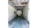 White walled open carport with beams and lighting, leads to the main house entrance at 708 Keeling St, Brooksville, FL 34601