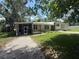 Charming single-story home with a screened porch and well-maintained lawn at 708 Keeling St, Brooksville, FL 34601