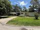 Well-kept single-story home with mature trees, driveway, and green lawn at 708 Keeling St, Brooksville, FL 34601