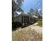 Exterior view showcasing a screened-in porch and the home's architectural style at 708 Keeling St, Brooksville, FL 34601