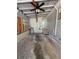 This is a garage featuring a concrete floor, a ceiling fan, storage and exterior access at 708 Keeling St, Brooksville, FL 34601