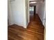 Hallway featuring hardwood floors and access to a screened-in porch at 708 Keeling St, Brooksville, FL 34601