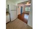 Bright kitchen with a modern white refrigerator and view into the living room at 708 Keeling St, Brooksville, FL 34601