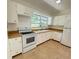 Charming kitchen with white appliances, ample cabinetry, and natural light at 708 Keeling St, Brooksville, FL 34601